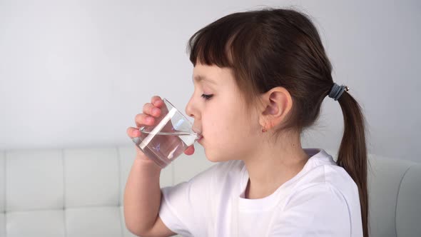 Cute Child Drinking Glass Fresh Transparent Pure Water at Home