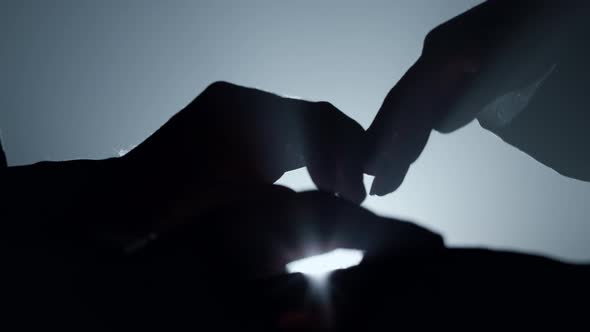 Silhouette Couple Hands Holding in Dark