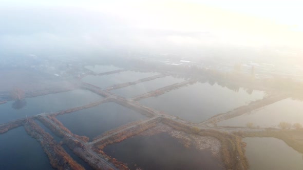 Aerial Drone View Flight Over Artificially Dug Ponds for Fish Farming Autumn