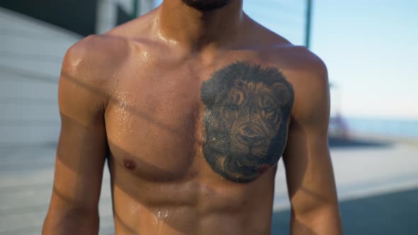 Sweat Athlete Man with Lion Tattoo Fit Cross Concept