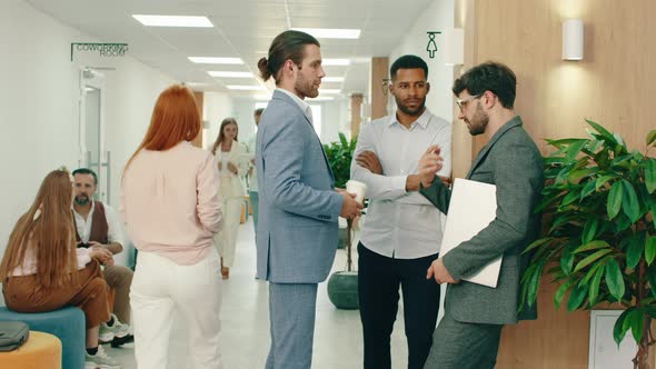 Three Handsome Workers are Having a Conversation