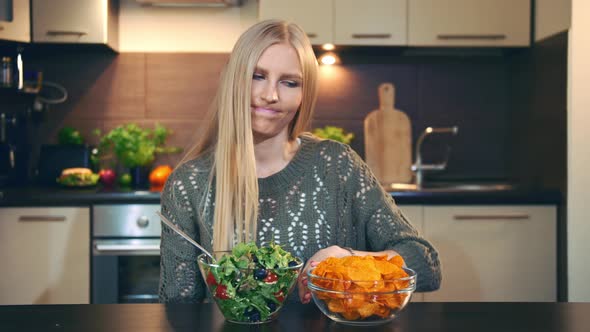 Young Lady Preferring Salad To Crisp