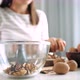 Young Woman Is Cracking a Walnuts and Collecting It in Glass Bowl, Close-up - VideoHive Item for Sale