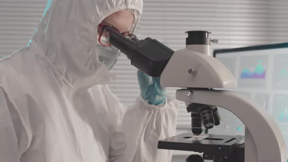 Female Researcher Using Microscope