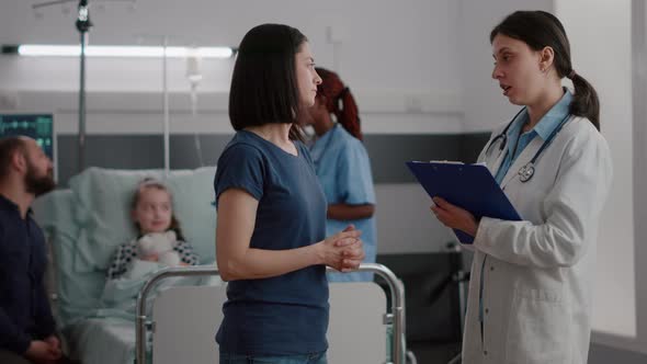 Pediatrician Woman Doctor Explaining Recovery Treatment to Worried Mother