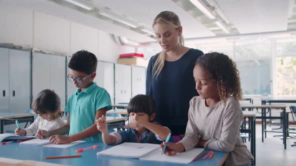 Young School Teacher Checking Task