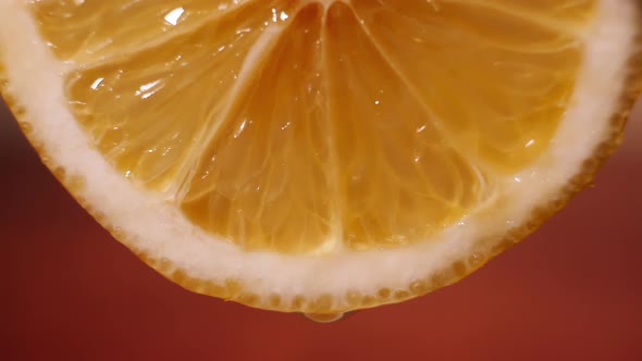 Juice Dripping From a Slice of Orange Macro Video