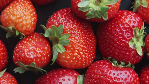 Strawberries Rotating on a Black Background. Natural Products Are Environmentally Friendly