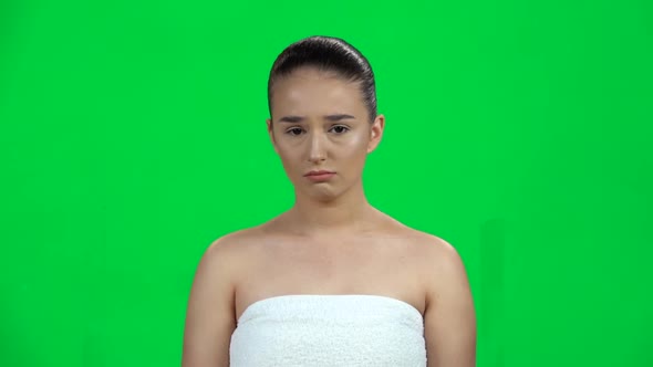 Woman Very Upset and Looking at the Camera on Green Screen at Studio. Slow Motion