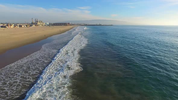 Aerial shot of a scenic beach shoreline at sunset