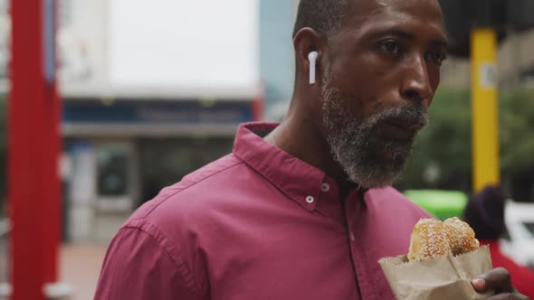 African American man eating in the street