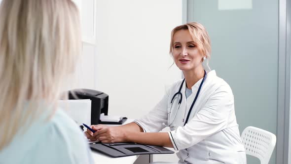 Young Blonde Woman at Doctor Reception in White Dressing Gown