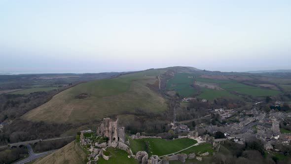 Aerial forward over Corfe Norman castle remains and surrounding landscape, Dorset county in England