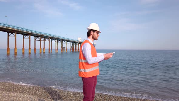 Engineer on the Beach near the Pier