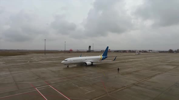 Passenger Airplane on Runway Preparing to Take off at Cloudy Weather at the Airport