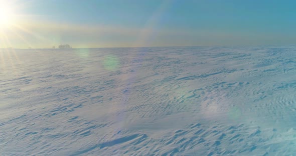 Aerial View of Cold Winter Landscape Arctic Field Trees Covered with Frost Snow Ice River and Sun