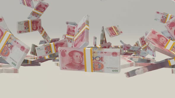 Many wads of money falling on table. 100 Chinese Yuan banknotes.