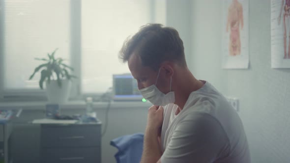 Man Patient Holding Shoulder After Vaccination Sitting Modern Clinic Close Up