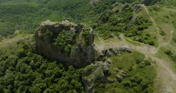 Rotating down shot taken from far away of the Azeula Fortress and a forest.