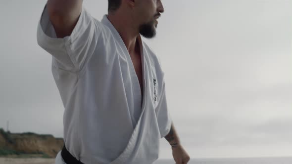 Kungfu Man Practicing Martial Arts on Beach Close Up