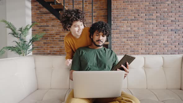 Naughty Child Distracts Freelance Father From Work on Laptop