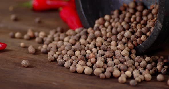 Grain of Black Pepper on the Table Slowly Rotating. 