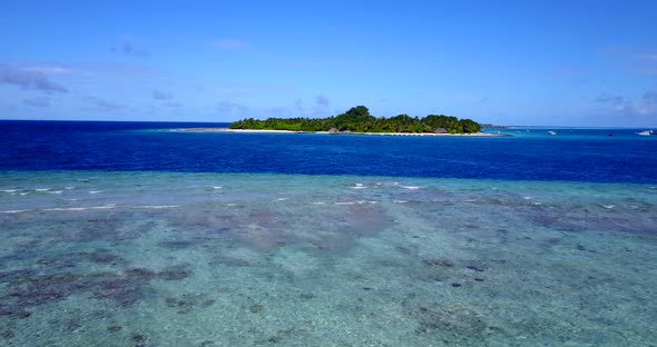 Wide aerial copy space shot of a paradise sunny white sand beach and blue water background in hi res