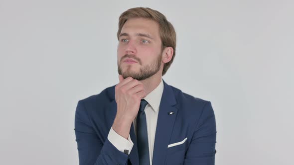 Pensive Young Businessman Thinking and Getting Idea on White Background