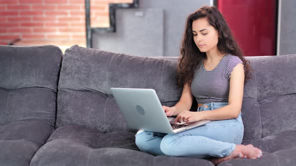 Happy Focused Freelancer Young Woman Working on Laptop at Living Room Full Shot