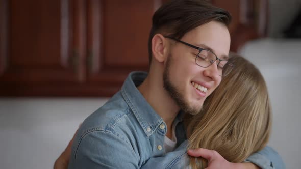 Happy Loving Man in Eyeglasses Hugging Woman Closing Eyes Enjoying Closeness