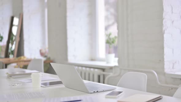 Young Professional Woman Coming in and Sitting in Office