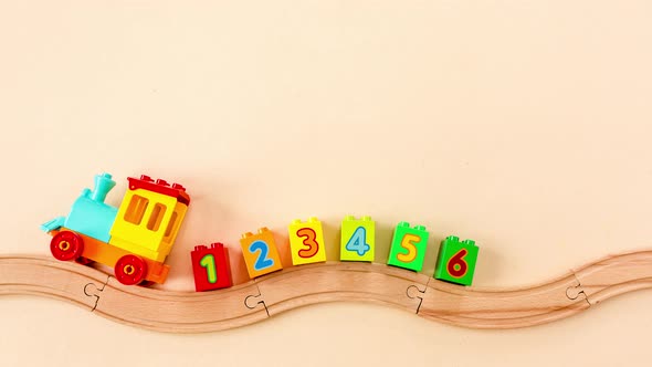 Stop Motion Animation Kids Toy Train with Numbers on Toy Wooden Railway on Yellow Background