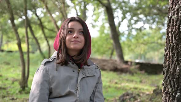 portrait of happy smiling young woman in forest natural park