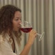Mixed Race Young Woman Drinks Alcohol Beverage at Home - VideoHive Item for Sale