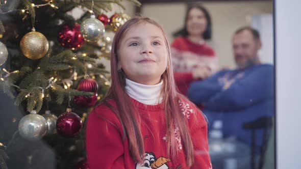 Thoughtful Dreamy Girl Waiting for Christmas Miracle. Middle Shot Portrait of Smiling Pretty