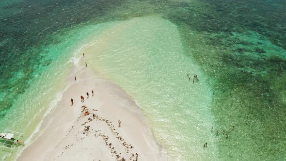 Sandy Island with a Beach and Tourists