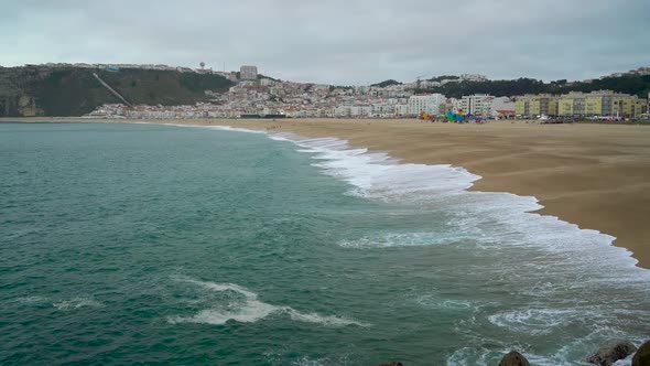 View of Nazare Atlantic Coast and Sandy Beach in Portugal. Slow Motion