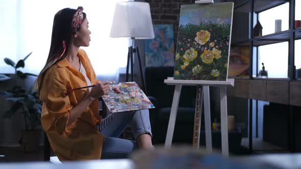 Young Female Artist Admiring Her Finished Painting