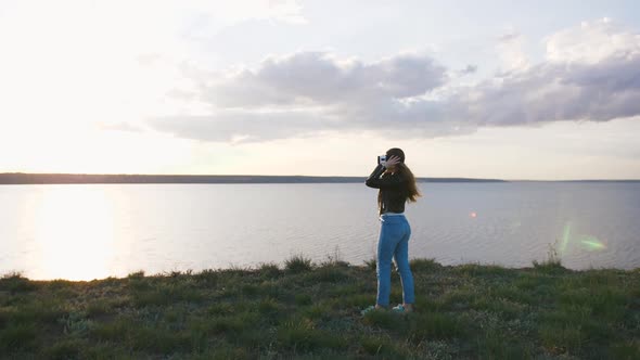 Portrait of Young Woman in Vr Glasses Outdoors with Beatiful Sea Sunset Background Slow Motion