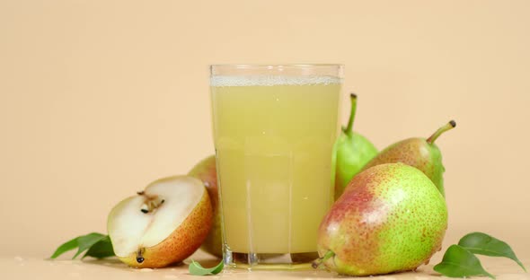 Pear Juice and Fresh Pears with Leaves Slowly Rotate. 