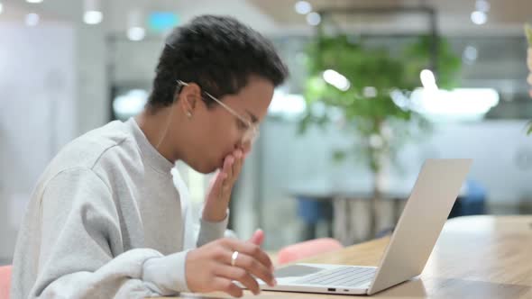 Casual African Woman with Laptop Coughing