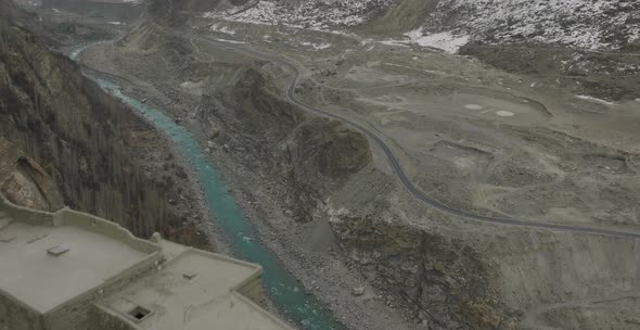 Aerial Flying Over Altit Fort In Hunza Valley From Over River Dolly Back