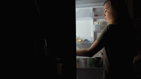 Woman Take Apple From Refrigerator at Night