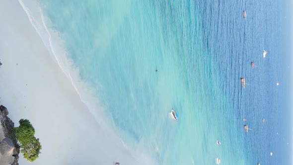 Vertical Video Boats in the Ocean Near the Coast of Zanzibar Tanzania Aerial View