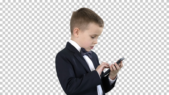 Young boy in elegance suit playing with mobile phone, Alpha Channel