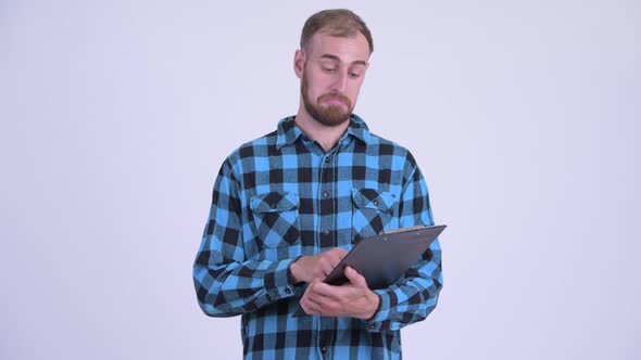 Happy Bearded Hipster Man Reading on Clipboard and Giving Thumbs Up