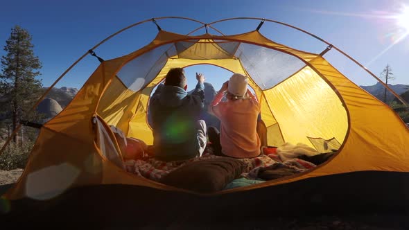 Camping at Yosemite National Park. Sierra Nevada Ridge. A Couple Takes a Selfie Sitting in a Tent.