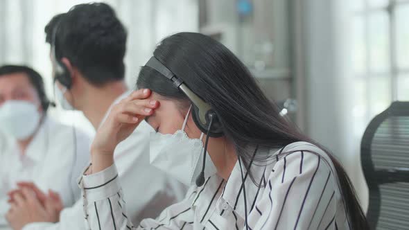 Asian Woman Call Centre Agents In Mask Headache Because Her Colleagues Are Talking During Working