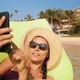 Young Mixed Race Girl Using Mobile Phone on Inflatable Mattress in Ocean - VideoHive Item for Sale
