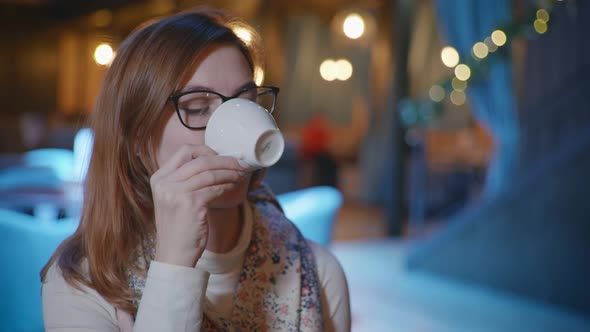 Portrait of Beautiful Girl in Glasses Have Fun on Coffee Break Drinking Espresso About Looking at